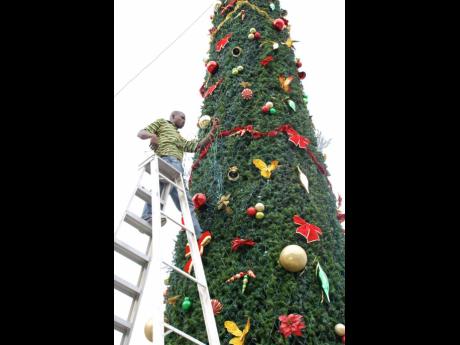 Vermon Taylor is pictured decorating the Christmas tree for the parish of St James.