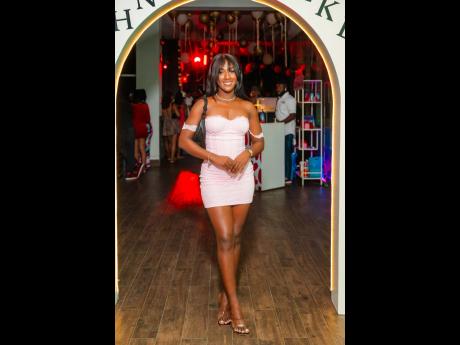 Nisa Wynter makes a confident entrance at Love Languages in her Outcast off-the-shoulder blush mini dress, paired with clear heels and a black shoulder bag.