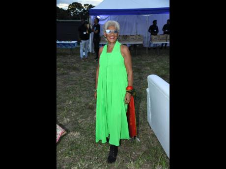 Credit: Antoine Lodge Dressed in lime green, Dr Sherrill Chong, community transformation specialist, brings festive spirit at the An Evening of Light, Music and Giving benefit concert.