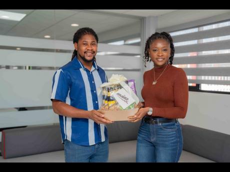 Malta Junior Brand Manager Laurice Griffiths presents Roshaun Wynter with a token of appreciation for his selfless leadership.