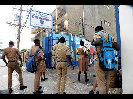 Credit: File In this file photo Holy Trinity High School students are seen locked out of the school premises.