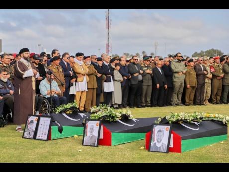 People attend funeral prayers for General Muhammad Ali Ahmad al-Haddad, coffin at left, in Misrata, Libya, who was killed with others in a plane crash.