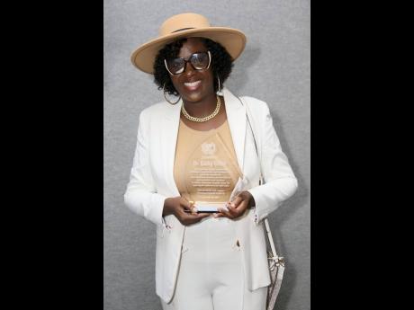 Dr Kathy Grant proudly displays her award, marking her long-standing contribution to the show.