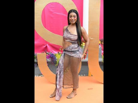Dr Ariana Powell prescribes confidence and sexy, rocking a Fashion Nova wrap dress with sheer detailing.