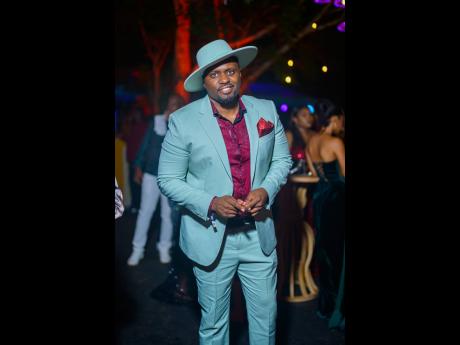 Attorney-at-law Clayton Lawrence dons a blue suit from Express and a matching fedora, with a deep burgundy shirt.