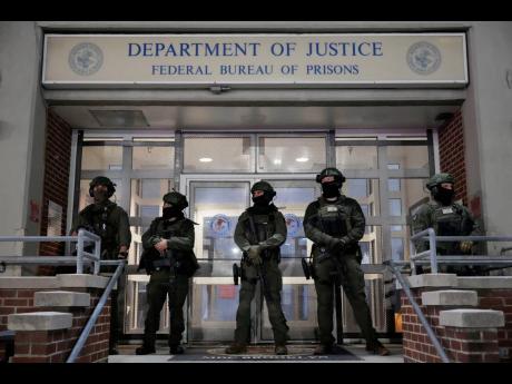 Federal law enforcement personnel stand watch outside the Metropolitan Detention Center as they await the arrival of captured Venezuelan President Nicolás Maduro in New York. 