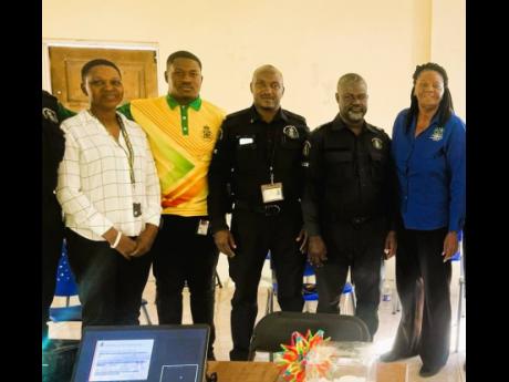 Dr Grace Kelly (right), Northern Caribbean University psychologist, poses with members of the Manchester Police Division after conducting a session on psychological first aid. 