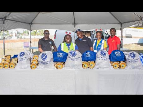 Credit: Contributed Members of the Food For The Poor Jamaica and Excelerate Energy teams getting ready to distribute food packages to families on the PATH programme in Hayes, Clarendon.