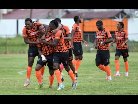 Credit: Antoine Lodge Akeil Leachman (second left) of Tivoli Gardens FC is congratulated by his teammates after scoring the first goal during their Jamaica Premier League football match against Portmore United at the Edward Seaga Sports Complex in Kingston yesterday. The game e