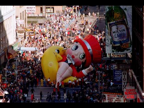 Betty Boop collapses on Broadway near 49th Street as handlers work to raise the deflated helium balloon during the Macy’s Thanksgiving Day Parade in New York, USA.  