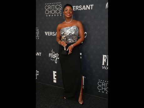 Janelle James, winner of the award for Best Supporting Actress in a Comedy Series for ‘Abbott Elementary’, in a black crepe column gown with a mirror-embroidered bust by Pamella Roland and Jimmy Choo heels.