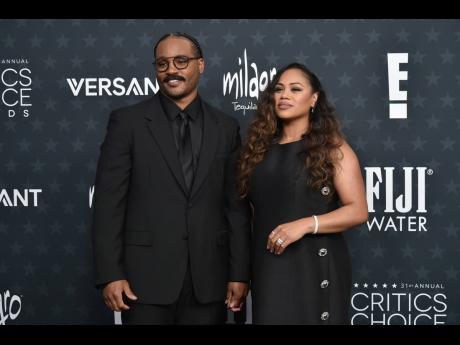 Ryan Coogler and wife Zinzi Evans hit the black carpet in Louis Vuitton. 