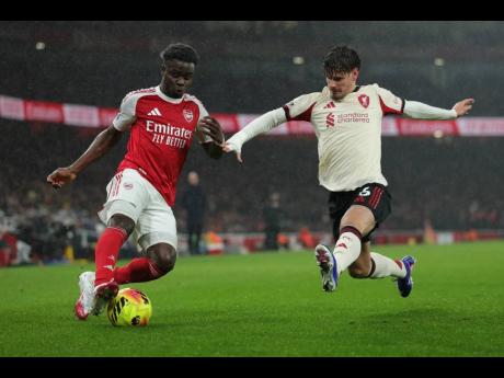 Credit: AP Liverpool’s Milos Kerkez (right) blocks Arsenal’s Bukayo Saka during the English Premier League match between Arsenal and Liverpool in London, yesterday.