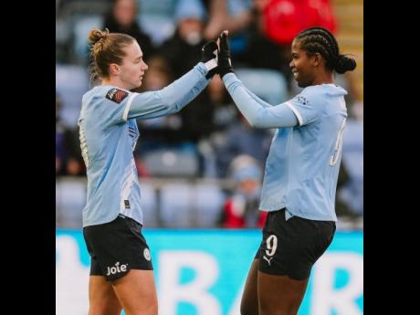 Credit: Courtesy of @mancitywomen Manchester City’s Khadija Shaw (right) congratulates teammate Miedema after her assist led to the latter’s goal during a Women’s Super League football game against Everton at the Joie Stadium in Manchester, England, yesterday.