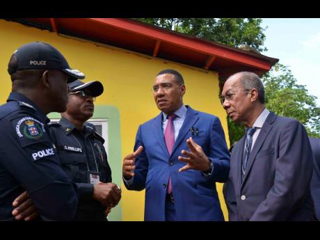 Credit: Antoine Lodge/Photographer Prime Minister Dr Andrew Holness (second right) in dialogue with Deputy Prime Minister and Minister of National Security, Dr Horace Chang (right), Police Commissioner Dr Kevin Blake (left) and Assistant Commissioner of Police for Area 5, Christopher Phill