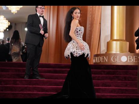Chase Infiniti mirrors the star-studded carpet in a custom Louis Vuitton corset gown.