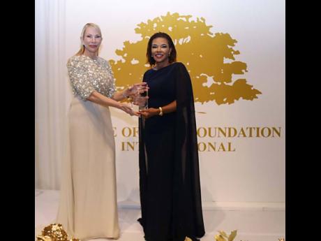 Credit: Photo by Derrick Scott Minister in the Office of the Prime Minister with responsibility for Efficiency, Innovation and Digital Transformation, Ambassador Audrey Marks receives the 2026 Golden Heart Award from Tree of Life Foundation President Amanda Schumacher.