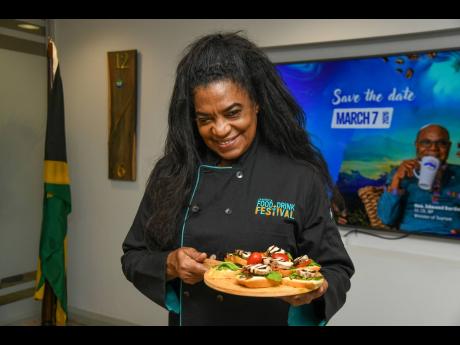 Credit: Matthew McKoy Chef Jacqui Tyson shows off her Blue Mountain Coffee-glazed jerk chicken breast crostini, topped with her signature coffee balsamic glaze, at the Jamaica Blue Mountain Coffee Day Celebration held at the Tourism Enhancement Fund Office in New Kingston, on J