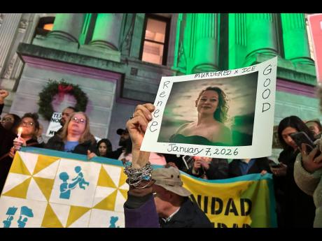 People gather in Philadelphia at an anti-immigration enforcement rally and vigil for Renee Good, who was shot and killed by an Immigration and Customs Enforcement officer in Minnesota. 