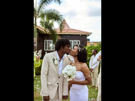 Right: The newly-weds seal the deal with a sweet kiss.