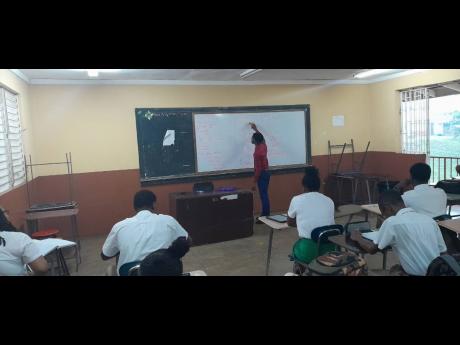 Denvor Green working as a teacher at Manchester High School.
