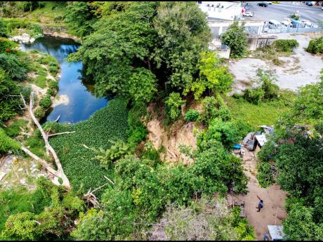 An aerial photograph of a house on Barrett Street in Spanish Town, St Catherine on Friday, July 17, 2020. The dwelling inches closer to the Rio Cobre with each heavy downpour of rainfall, as a result of soil erosion. 