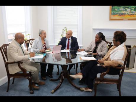 Credit: Derrick Scott photo Jamaica’s Ambassador to the United Statea, Major General (Ret’d) Antony Anderson (centre), discusses Jamaica’s overseas employment programmes with Permanent Secretary in the Ministry of Labour and Social Security, Colette Roberts Risden (second left)