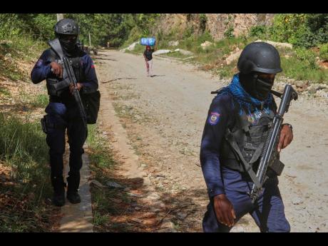 Police officers patrol the area near the Saint-Helene orphanage in the Kenscoff neighbourhood of Port-au-Prince, Haiti, Monday, August 4, 2025. (AP Photo/Odelyn Joseph)