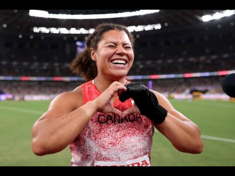 Credit: Courtesy of World Athletics Canada’s Camryn Rogers celebrates winning gold in the Hammer Throw at the World Athletics Championships in Tokyo last year. The glove on her hand was donated to the Museum of World Athletics yesterday.