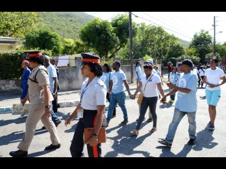In this 2017 photo members of the Jamaica Constabulary Force are seen participating in a peace march.