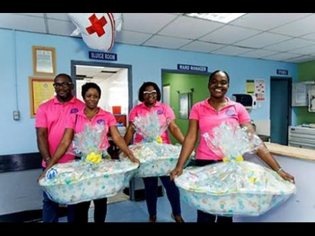 Credit: Contributed JDF Credit Union staff prepare to deliver care baskets at the Victoria Jubilee Hospital, providing practical support to first-time mothers for Mother’s Day.