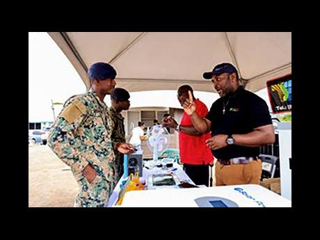 Credit: Contributed A JDF Credit Union member speaks with an exhibitor at the Annual House & Home Expo, exploring products for home ownership.