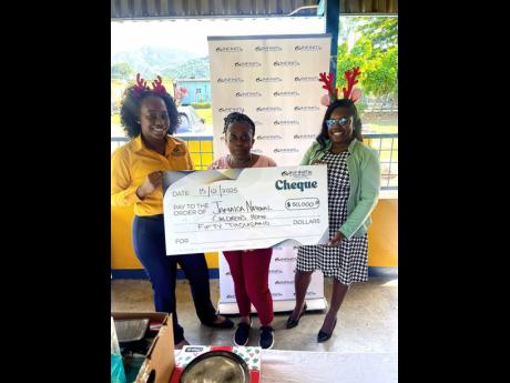  At the Jamaica National Children’s Home in Kingston, staff from Infiniti Co-operative Credit Union personally deliver a $50,000 donation as part of the Hope for the Holidays initiative. 