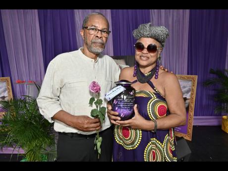 Ricardo Munoz Bennett holds a single rose while Bridgett Anderson cradles the urn at the thanksgiving service for the life of Ricardo Anthony Munoz-Bennett.