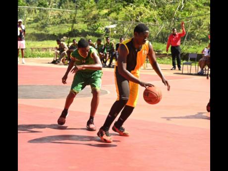 York Castle High’s Omar Campbell (right) dribbles away from  Belair High’s Raheem Irvin during their ISSA Rural Schoolboys Basketball match at York Castle’s court on Wednesday, January 28, 2026.