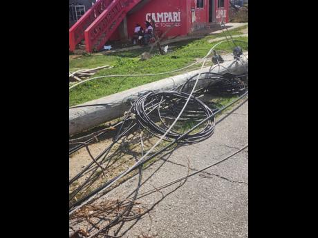 A downed utility pole showing mainly wires belonging to Hometime Cable after the passage of Hurricane Melissa.