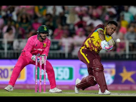 
West Indies batsman Shimron Hetmyer (right) plays a shot as South Africa’s wicketkeeper Quinton de Kock watches on during the final T20 International in Johannesburg, South Africa, yesterday. The West Indies won by six runs.