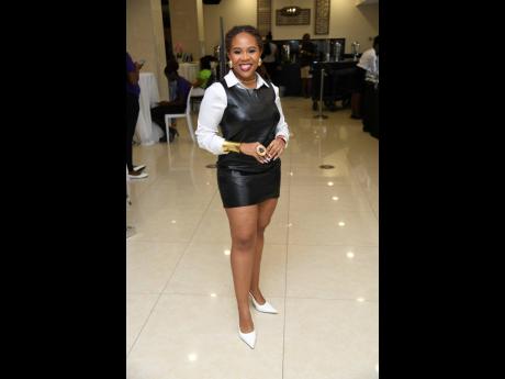 Media personality Daindra Harrison strikes a pose for our lens, donning a leather mini, styled with pops of white and gold.