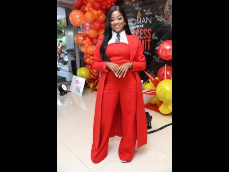 Stylish in red, worship leader Kayann Ledford pairs a jumpsuit with a coat and tie.