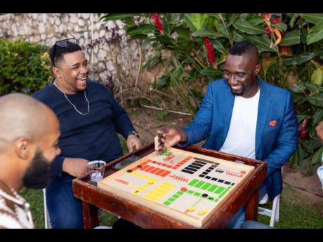 It was an evening of good vibes, great energy, and genuine connection as Mark McKenzie (right), SME relationship manager, JMMB Bank; Earl McDonald of VL BPO Limited, and Jordan Wright (left) of SJOJ Limited, enjoy a game of Ludo.