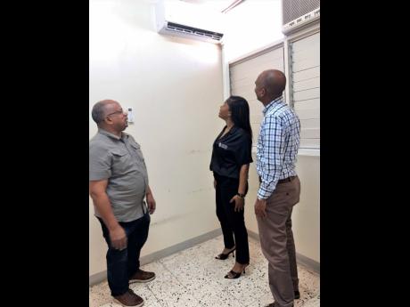Christopher Ffrench (left), medical officer in Accident & Emergency at Kingston Public Hospital; Jhana Edwards, marketing manager at Supreme Ventures Limited; and Igol Allen, blood donor organiser, discuss the impact of the newly donated air conditioning u