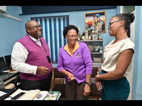 Reverend Claude Ellis, principal of Pembroke Hall High School, with his vice-principals Yvette Shield-Green (centre) of resource and operations and Stacy-Ann McIntosh-Richard, at the school’s Ken Hill Drive, St Andrew location last Wednesday. 