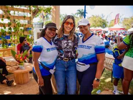 Marking 28 years of keeping participants refreshed at Sigma, Catherine’s Peak Brand Manager, Rochell Samuels-Black (left), and Allawney Bromley (right), senior brand manager for beverages, GraceKennedy Ltd.,  join Nicole Campbell Robinson, vice president