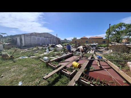 A nearby building damaged following the passage of Hurricane Melissa. 