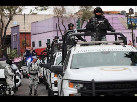 National Guards patrol the area outside of the General Prosecutor's headquarters in Mexico City, Sunday, February 22, 2026, after authorities reported that the Mexican Army killed Jalisco New Generation Cartel leader Nemesio Oseguera, known as "El Mencho."