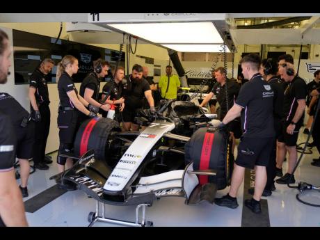 
Mechanics of Cadillac driver Valtteri Bottas of Finland prepare his car during a Formula One pre-season test at the Bahrain International Circuit in Sakhir, Bahrain.