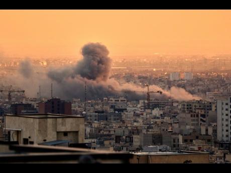 A plume of smoke rises following a US-Israeli military strike in Tehran, Iran, on Tuesday, March 3.