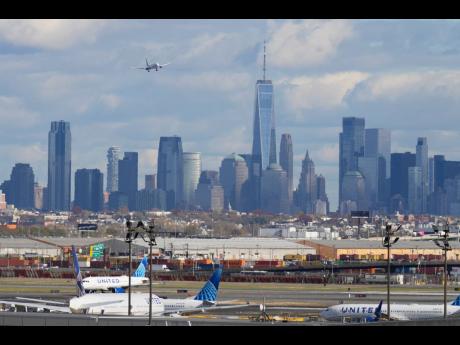 The New York City skyline with a plane approaching an airport on November 6, 2025.  AP 