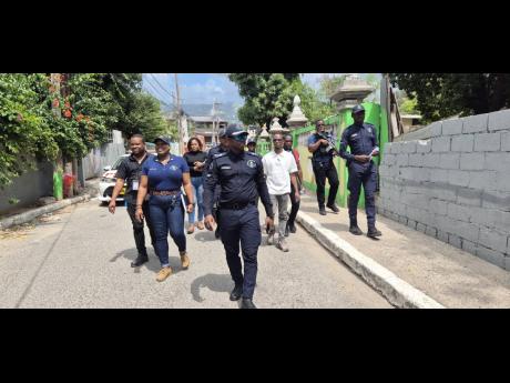 Members of the St Andrew North Police Division and other stakeholders on a community walkthrough in Grants Pen, St Andrew on March 6.