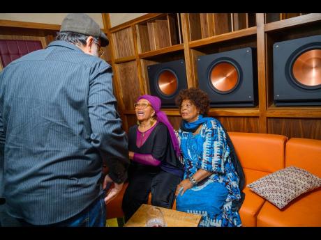 Reggae icons Marcia Griffiths and Judy Mowatt are greeted by Opposition Leader Mark Golding, member of parliament for St Andrew Southern.
